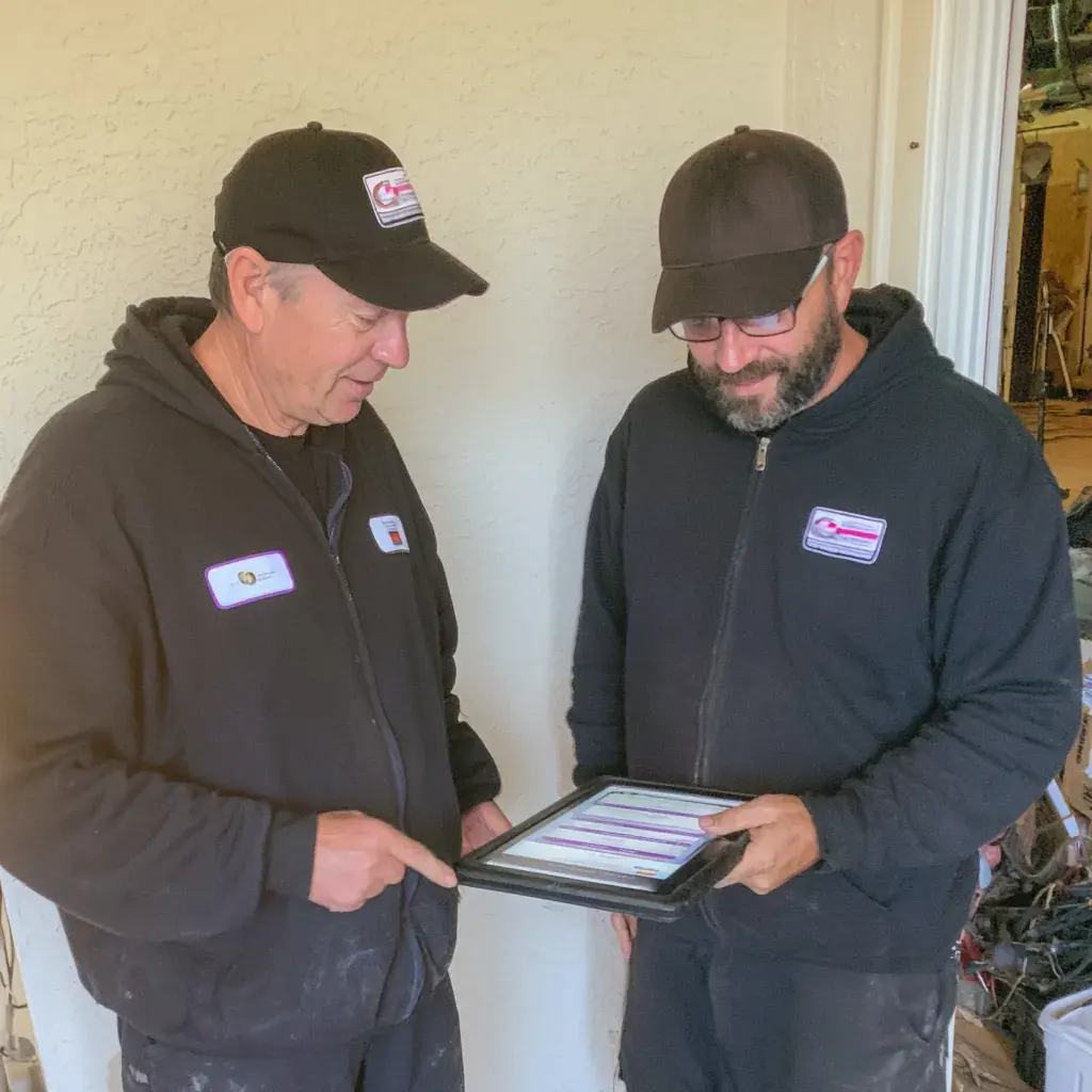 Homeowner and technician going over a garage door in central Indiana